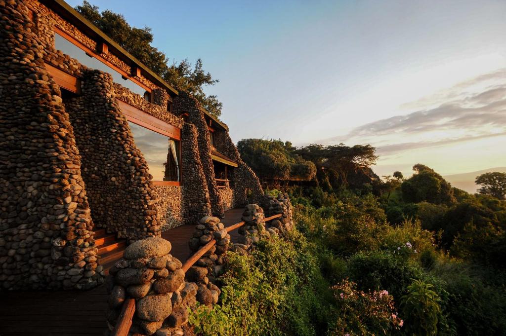 The exterior of the Ngorongoro Serena Safari Luxury Lodge features combined rocks as a barrier between the accommodations