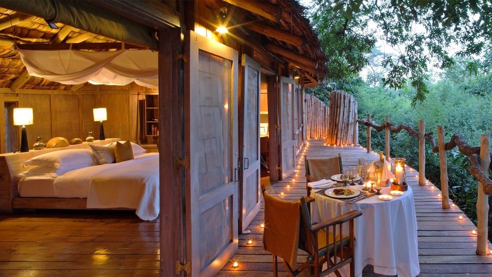 The luxury in Tanzania comes with a great wood interior and a romantic table and lights on a terrace