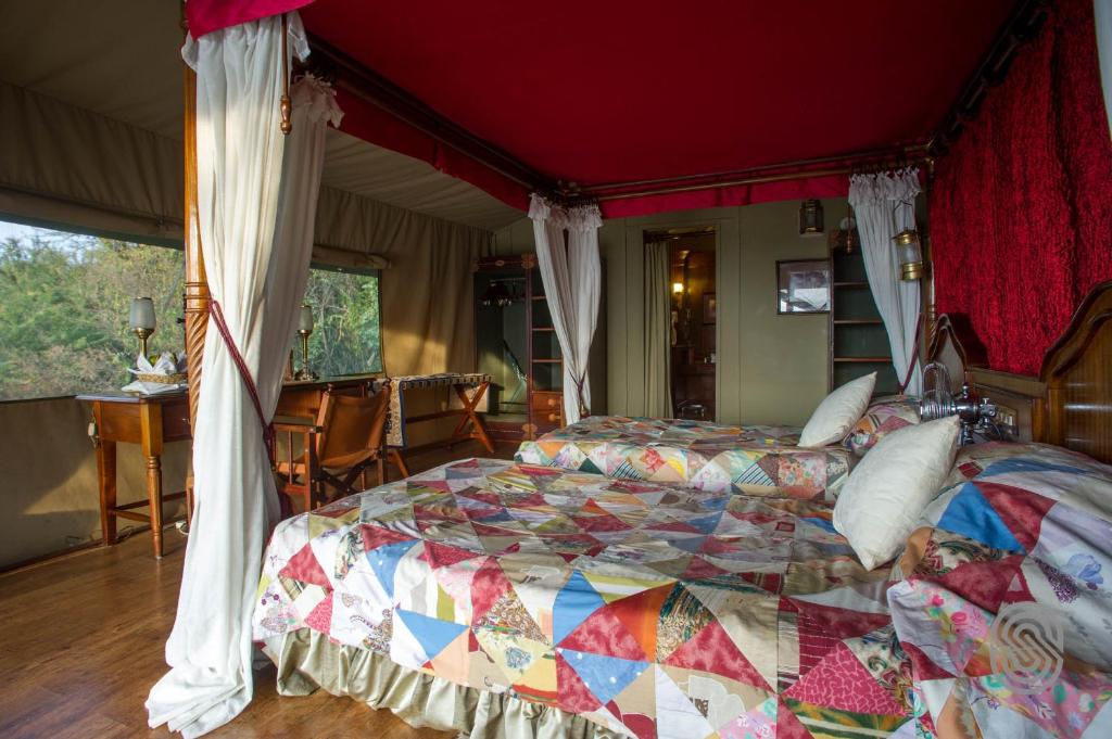 The Serena Kirawira Luxury Camp tented with two king size bedrooms, tables and chairs